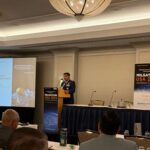 Lt. Col. Allen Varghese, deputy director of DIU’s Space Portfolio, speaking at MILSATCOM USA on June 16, 2025. (LJB)