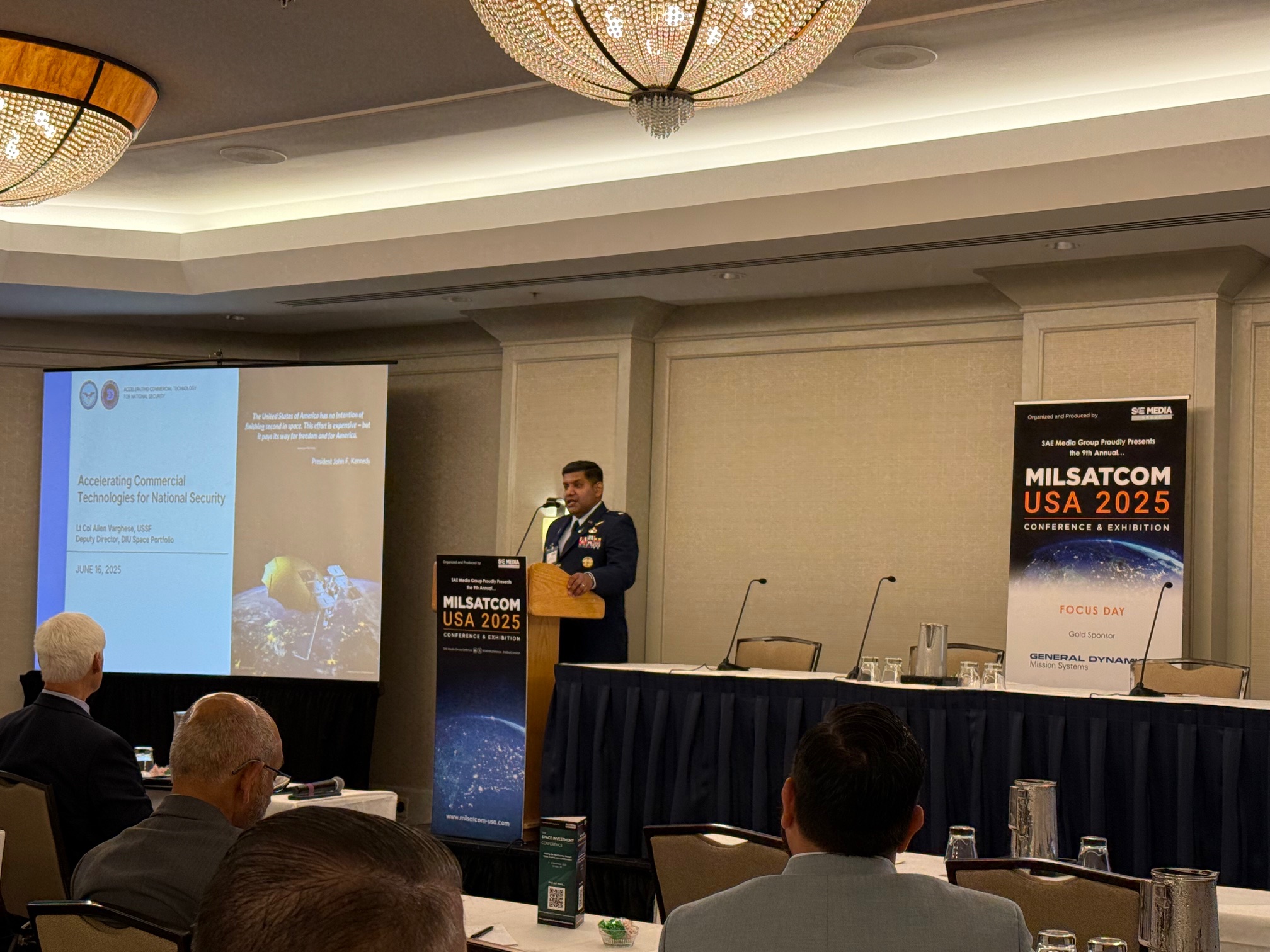 Lt. Col. Allen Varghese, deputy director of DIU’s Space Portfolio, speaking at MILSATCOM USA on June 16, 2025. (LJB)